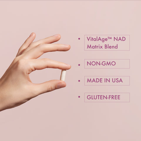 Hand holding a supplement pill with product details on a pink background